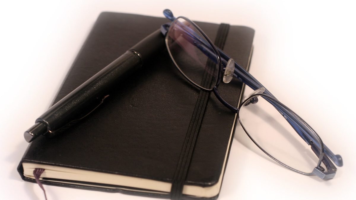 Planner and glasses on a desk, renewing an ESA letter each year