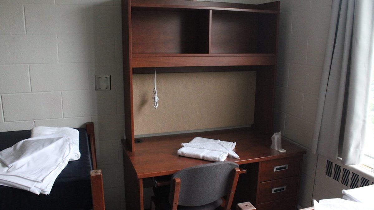 University dorm room with desk and bed, requesting an ESA accommodation