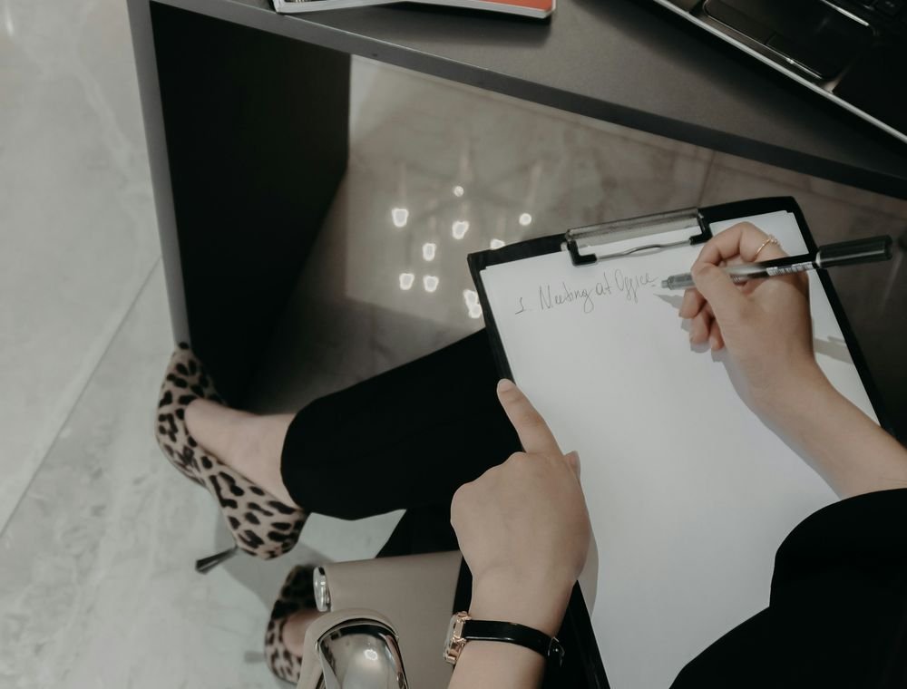 Clinician writing evaluation notes on a clipboard